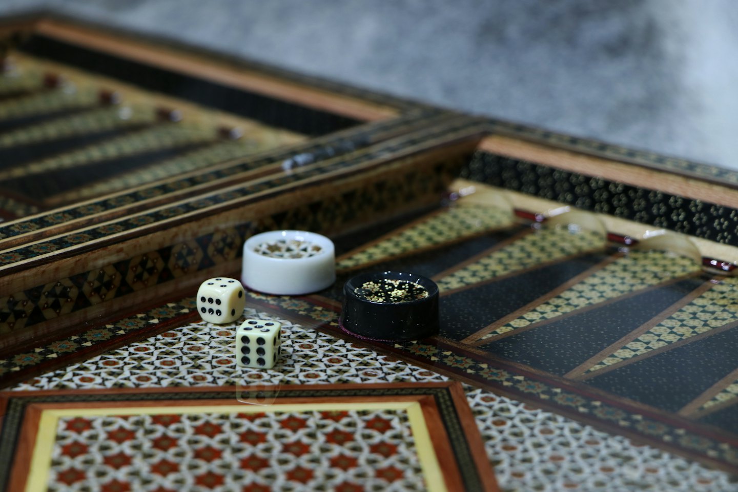 Wooden backgammon board with dice and checkers.