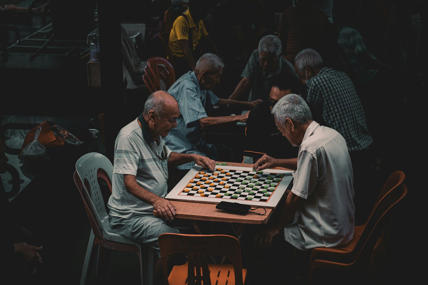 Men playing a board game together at a table.